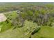 This aerial view captures the home surrounded by lush trees, offering a private and serene setting at 8654 N Baltimore Rd, Monrovia, IN 46157