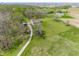 High-angle captures the property, highlighting its extensive yard and private driveway winding through lush greenery at 8654 N Baltimore Rd, Monrovia, IN 46157