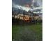 Scenic backyard view with green grass, bare trees, and a vibrant sunset sky at 8654 N Baltimore Rd, Monrovia, IN 46157
