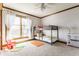 Sunlit bedroom with a bunk bed, a ceiling fan, and carpet at 8654 N Baltimore Rd, Monrovia, IN 46157