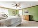 Cozy bedroom featuring a bed, dresser, carpet, and bright green walls at 8654 N Baltimore Rd, Monrovia, IN 46157