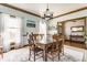 A classic dining room with wood table, chandelier, and large windows creates a warm and inviting space at 8654 N Baltimore Rd, Monrovia, IN 46157