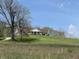 Charming home featuring a front porch on a hill, complemented by a green lawn and blue sky at 8654 N Baltimore Rd, Monrovia, IN 46157