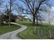 Charming home featuring a front porch on a hill, complemented by a winding driveway and mature trees at 8654 N Baltimore Rd, Monrovia, IN 46157