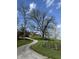 Charming home featuring a front porch on a hill, complemented by a winding driveway and mature trees at 8654 N Baltimore Rd, Monrovia, IN 46157