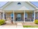 A cozy front porch features seating and decorative plants, enhancing the home's curb appeal at 8654 N Baltimore Rd, Monrovia, IN 46157