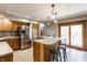 A well-equipped kitchen features wood cabinets, stainless steel appliances, and a functional island with seating at 8654 N Baltimore Rd, Monrovia, IN 46157