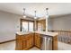 Bright kitchen featuring an island with a stainless steel dishwasher and sink at 8654 N Baltimore Rd, Monrovia, IN 46157