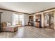 Bright living room with wood trim, large window, and hardwood floors at 8654 N Baltimore Rd, Monrovia, IN 46157