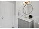 Stylish bathroom with a modern vanity, round mirror, and elegant fixtures at 8834 Pin Oak Dr, Zionsville, IN 46077