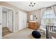 Charming bedroom featuring a changing table, rocker, closet and natural light from the window at 8834 Pin Oak Dr, Zionsville, IN 46077