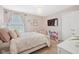 Light and airy bedroom with TV, books and neutral decor at 8834 Pin Oak Dr, Zionsville, IN 46077