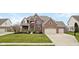Attractive brick home with well-manicured lawn and three-car garage at 8834 Pin Oak Dr, Zionsville, IN 46077