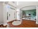 Welcoming foyer featuring wood floors, arched doorways, and a view of a cozy office space at 8834 Pin Oak Dr, Zionsville, IN 46077