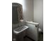 Half-bath with pedestal sink, floral patterned mirror, and tile flooring at 8955 Stonegate Rd # A, Indianapolis, IN 46227