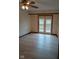 Bedroom with wood trim, a ceiling fan, and access to a balcony through a set of glass doors at 8955 Stonegate Rd # A, Indianapolis, IN 46227