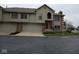 Charming townhome featuring a brick facade, attached garage, and well-maintained landscaping at 8955 Stonegate Rd # A, Indianapolis, IN 46227