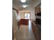 Open kitchen featuring wood cabinets, a center island, and views to the outdoors through glass doors at 8955 Stonegate Rd # A, Indianapolis, IN 46227