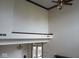 View of living room with high ceilings, wood trim, and an ornate ceiling fan with light fixture at 8955 Stonegate Rd # A, Indianapolis, IN 46227