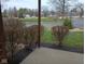 Exterior view overlooking well-maintained landscaping and a tranquil pond at 8955 Stonegate Rd # A, Indianapolis, IN 46227