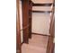 Spacious walk-in closet with wood trim, shelving, and hanging rods at 8955 Stonegate Rd # A, Indianapolis, IN 46227