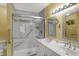 Bright bathroom with a double vanity, a walk-in shower with glass doors and grab bars at 9242 Golden Leaf Way, Indianapolis, IN 46260