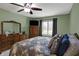 Green Primary bedroom with a ceiling fan, large window, and traditional wood furniture, providing a cozy retreat at 9242 Golden Leaf Way, Indianapolis, IN 46260