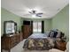 Green Primary bedroom with a ceiling fan, large window, and traditional wood furniture, providing a cozy retreat at 9242 Golden Leaf Way, Indianapolis, IN 46260