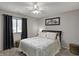Comfortable bedroom with ceiling fan, large window and neutral tones, creating a relaxing atmosphere at 9242 Golden Leaf Way, Indianapolis, IN 46260