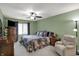 Green Primary bedroom with a ceiling fan, large window, and comfortable armchair, providing a cozy retreat at 9242 Golden Leaf Way, Indianapolis, IN 46260