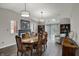 Bright dining room features a fireplace, stylish lighting, and backyard access at 9242 Golden Leaf Way, Indianapolis, IN 46260