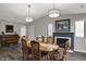 Charming dining room with a fireplace, piano, and elegant furnishings at 9242 Golden Leaf Way, Indianapolis, IN 46260