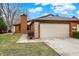 Exterior showcases a two-car garage with a clean driveway and manicured lawn at 9242 Golden Leaf Way, Indianapolis, IN 46260
