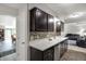Spacious kitchen with dark cabinetry, modern appliances, and an open view to the living area at 9242 Golden Leaf Way, Indianapolis, IN 46260