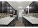 Modern kitchen featuring dark cabinets, stainless steel appliances, and spacious countertops at 9242 Golden Leaf Way, Indianapolis, IN 46260