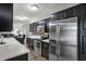 Modern kitchen featuring stainless steel appliances, dark cabinets, and an open layout at 9242 Golden Leaf Way, Indianapolis, IN 46260