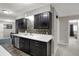 Charming kitchen with dark cabinetry, stainless steel appliances, and a sleek countertop at 9242 Golden Leaf Way, Indianapolis, IN 46260