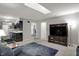 Bright living room with a large TV, modern furnishings, and an open layout at 9242 Golden Leaf Way, Indianapolis, IN 46260