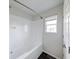 Bathroom featuring a tub, shower, and window for natural light at 1045 Evening Shade Cir, Beech Grove, IN 46107