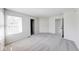 Spacious bedroom with neutral carpet, natural light from window, and easy access to en-suite bathroom at 1045 Evening Shade Cir, Beech Grove, IN 46107