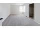 Bright bedroom with neutral carpet, walk-in closet, and natural light at 1045 Evening Shade Cir, Beech Grove, IN 46107