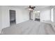 Spacious bedroom with neutral carpet, a ceiling fan, and an ensuite bathroom at 1045 Evening Shade Cir, Beech Grove, IN 46107