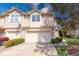 Inviting townhouse featuring a two-car garage, charming landscaping, and stone facade accents at 1045 Evening Shade Cir, Beech Grove, IN 46107