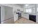 Well-lit kitchen featuring stainless steel appliances, white cabinets, and marble countertops at 1045 Evening Shade Cir, Beech Grove, IN 46107