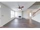 Bright and airy living room with fireplace, wood floors, a ceiling fan, and a staircase at 1045 Evening Shade Cir, Beech Grove, IN 46107