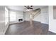 Spacious living room with a fireplace, wooden floors, staircase, and abundant natural light at 1045 Evening Shade Cir, Beech Grove, IN 46107