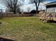 Large, fenced backyard featuring a spacious lawn and deck, perfect for outdoor enjoyment at 109 S County Line Rd, , IN 47272