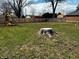 Spacious backyard featuring a large lawn, fenced perimeter, and a charming playground set at 109 S County Line Rd, , IN 47272