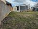 A fenced backyard showcases a well-maintained lawn, shed, and the home's exterior at 109 S County Line Rd, , IN 47272