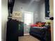 Cozy bedroom featuring a window with decor, a black dresser and a TV at 109 S County Line Rd, , IN 47272
